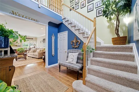 a living room with furniture and a potted plant