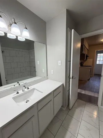 a spacious bathroom with a sink double vanity and a mirror