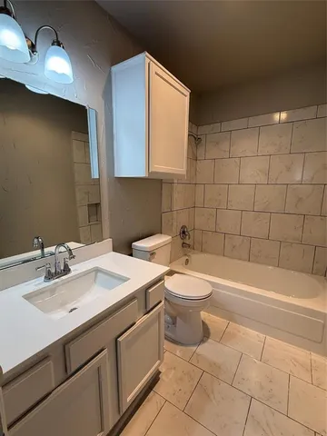 a bathroom with a sink a toilet and bathtub