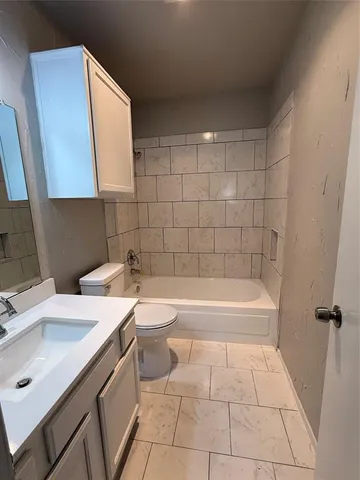 a bathroom with a sink a toilet and bathtub