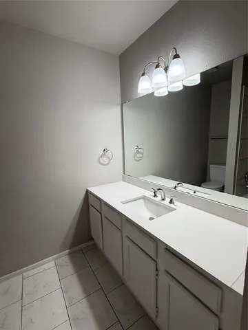 a bathroom with a sink vanity and a mirror