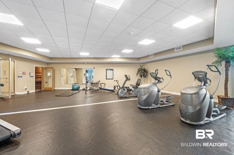 27800 Canal Road, Unit 411 Orange Beach, AL 36561 - Photo 44 of 49 Dedicated fitness center featuring rubber flooring, recessed lighting, and mirrored walls