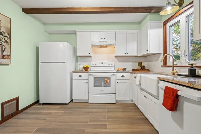 a kitchen with a white cabinets and white appliances