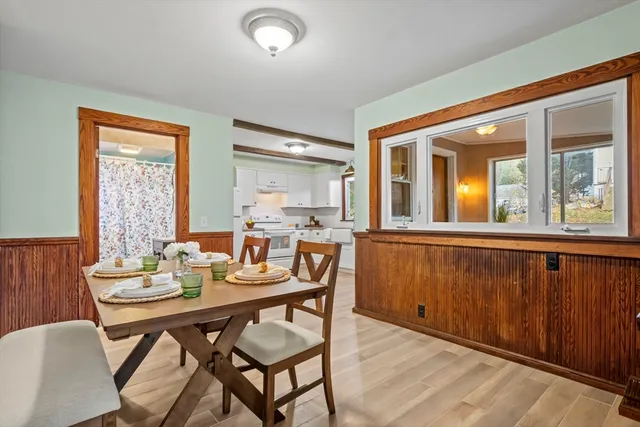 a dining room with furniture and window