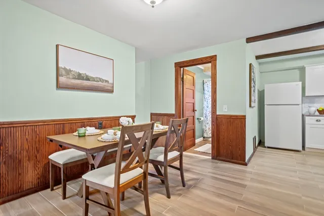 a dining room with furniture and wooden floor