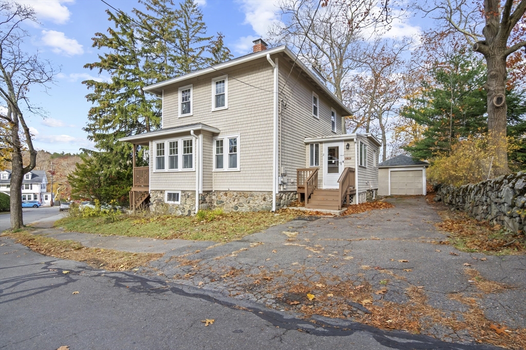 2 Overlook Road Wakefield, MA 01880 - Photo 2 of 42 a front view of a house with a yard and garage