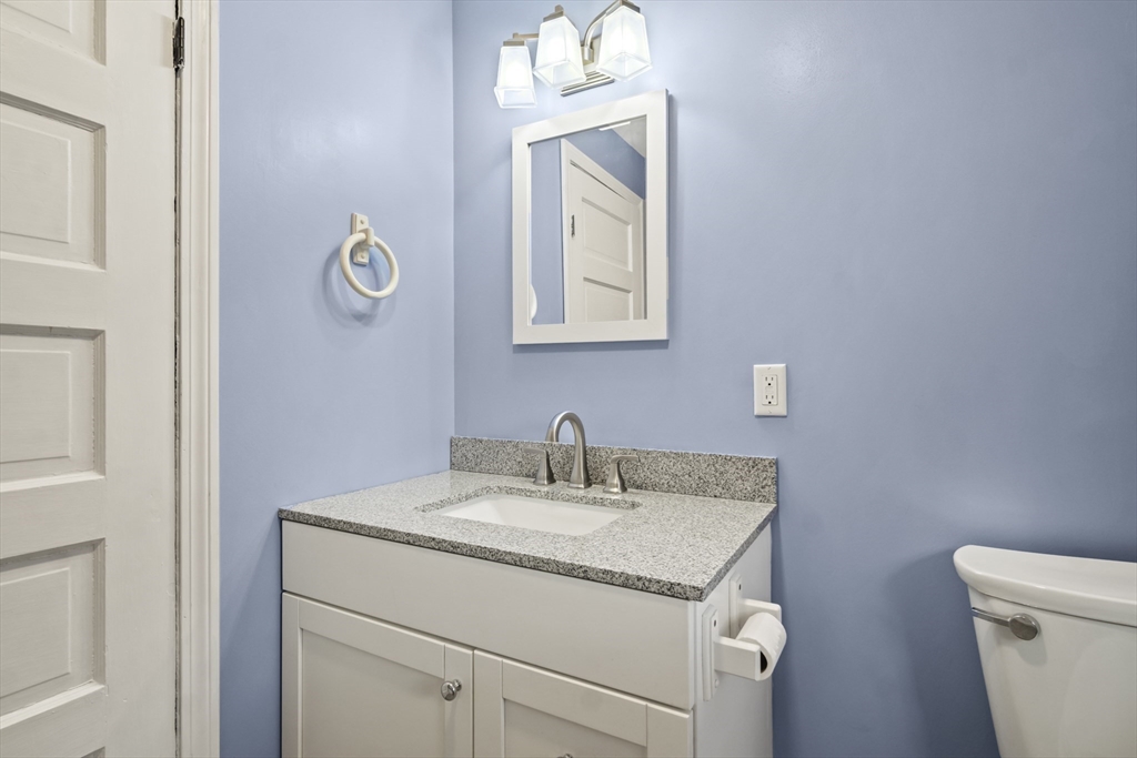 2 Overlook Road Wakefield, MA 01880 - Photo 23 of 42 a bathroom with a granite countertop sink a toilet and mirror