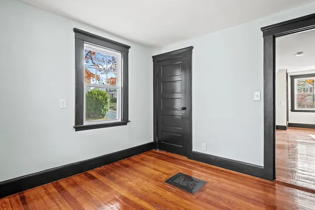 wooden floor in an empty room with a window