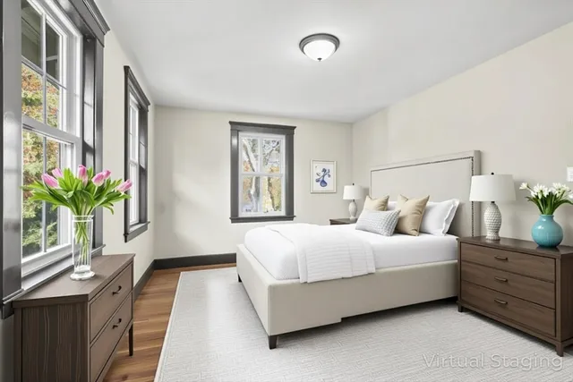 a bedroom with a bed and a potted plant