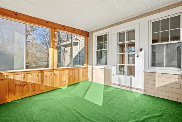 a view of an house with backyard and porch