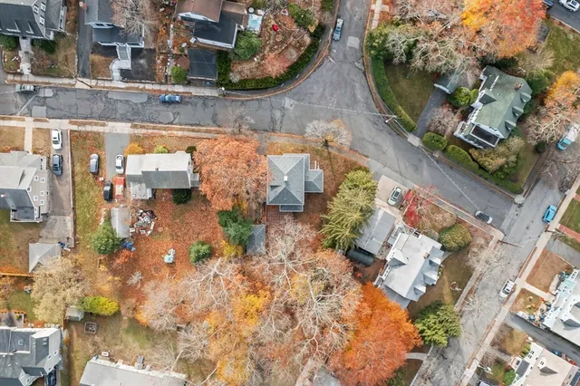 an aerial view of a house with a garden and lake view