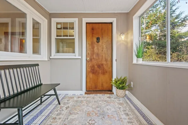 a view of a door and wooden floor