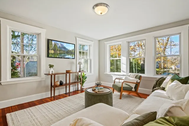 a living room with furniture and large windows
