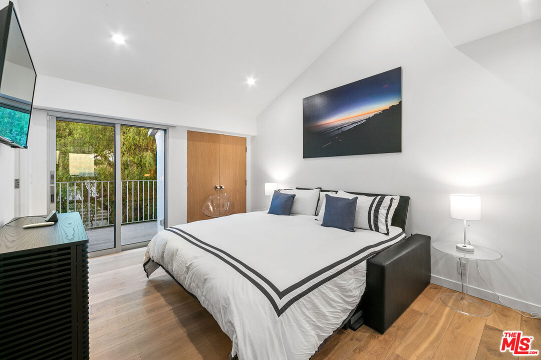 31666 Broad Beach Road Malibu, CA 90265 - Photo 14 of 23 a large bedroom with a bed and glass window