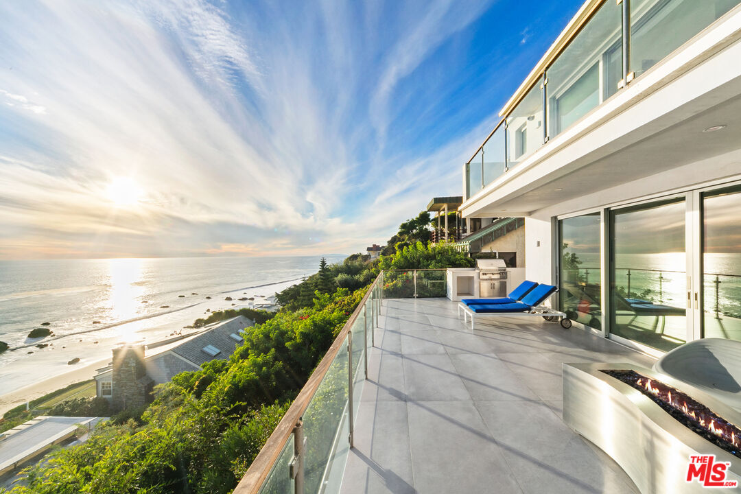 31666 Broad Beach Road Malibu, CA 90265 - Photo 20 of 23 a view of a balcony with chairs and wooden floor