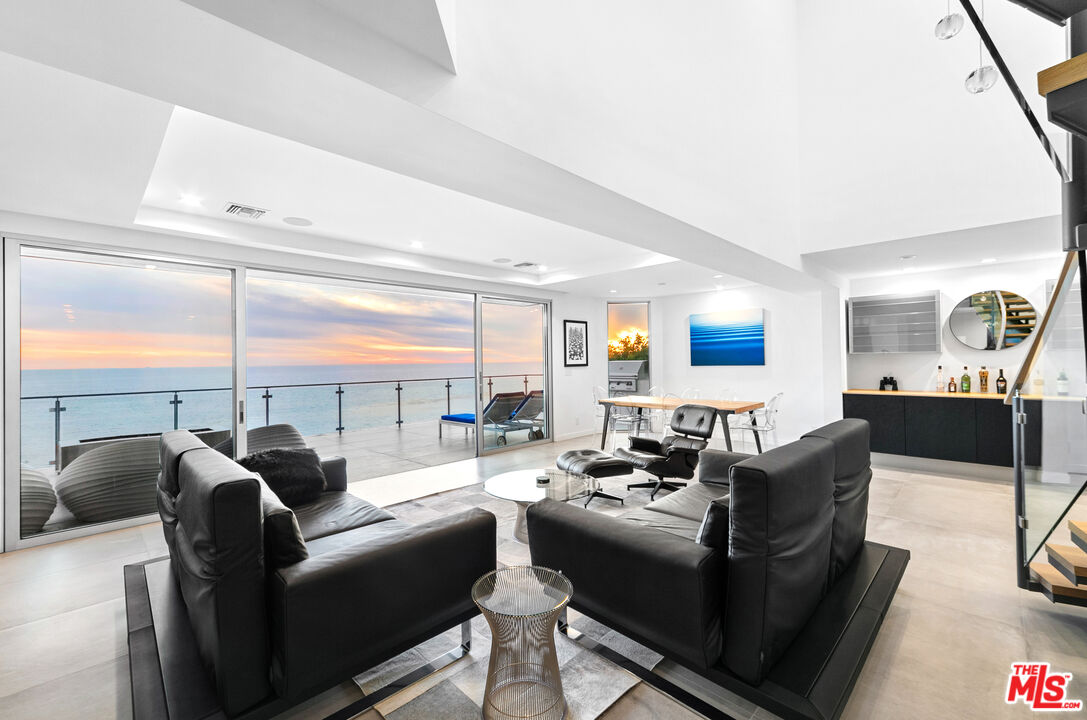 31666 Broad Beach Road Malibu, CA 90265 - Photo 6 of 23 a living room with furniture a rug and a floor to ceiling window