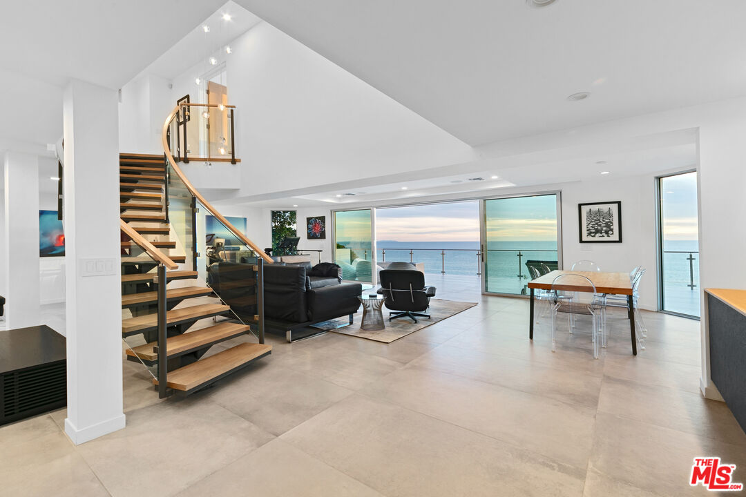 31666 Broad Beach Road Malibu, CA 90265 - Photo 7 of 23 a living room with furniture and a dining table with kitchen view