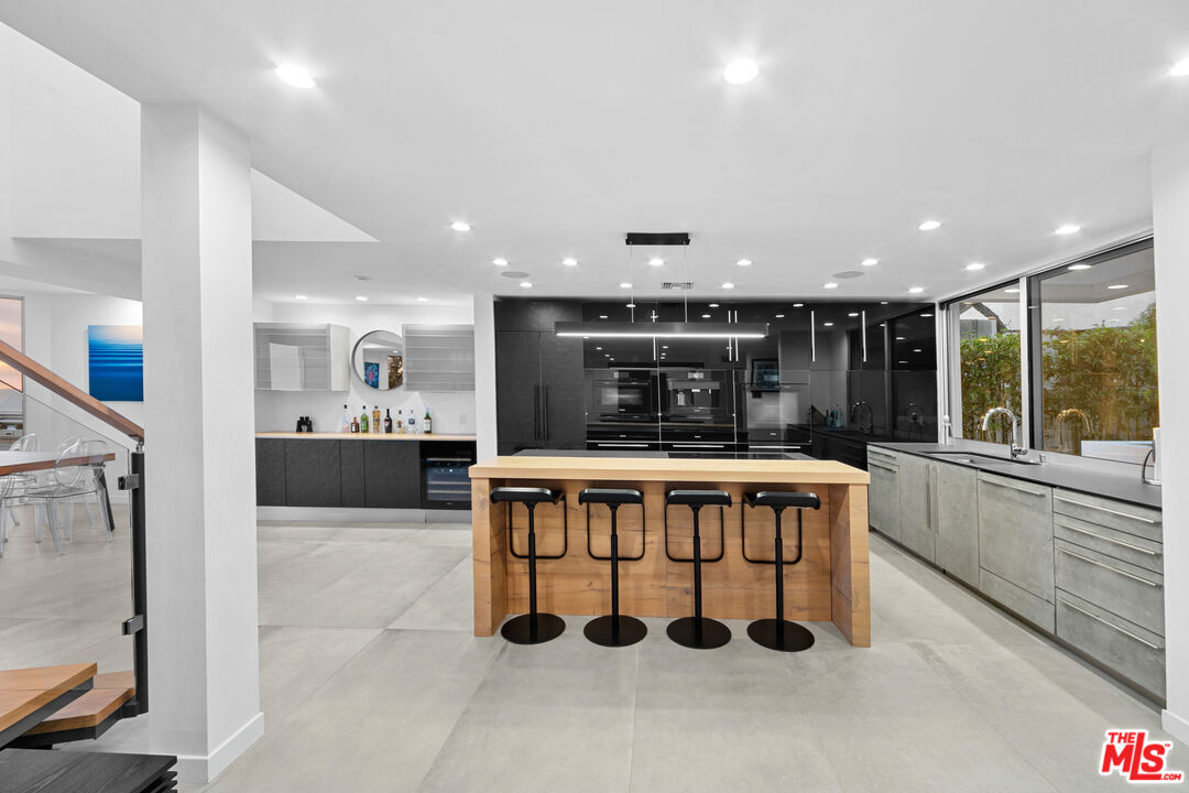 31666 Broad Beach Road Malibu, CA 90265 - Photo 8 of 23 a large kitchen with a large counter top furniture a sink and stainless steel appliances