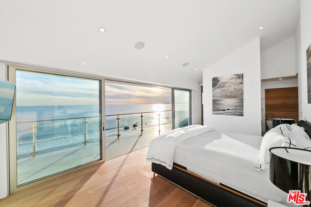 31666 Broad Beach Road Malibu, CA 90265 - Photo 10 of 23 a room with a bed and a flat screen tv