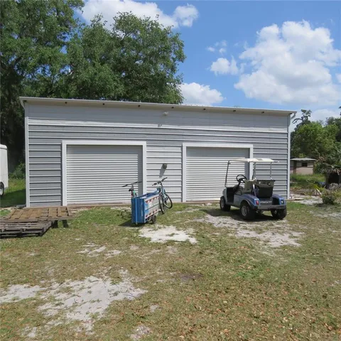a view of a house with a yard and garage