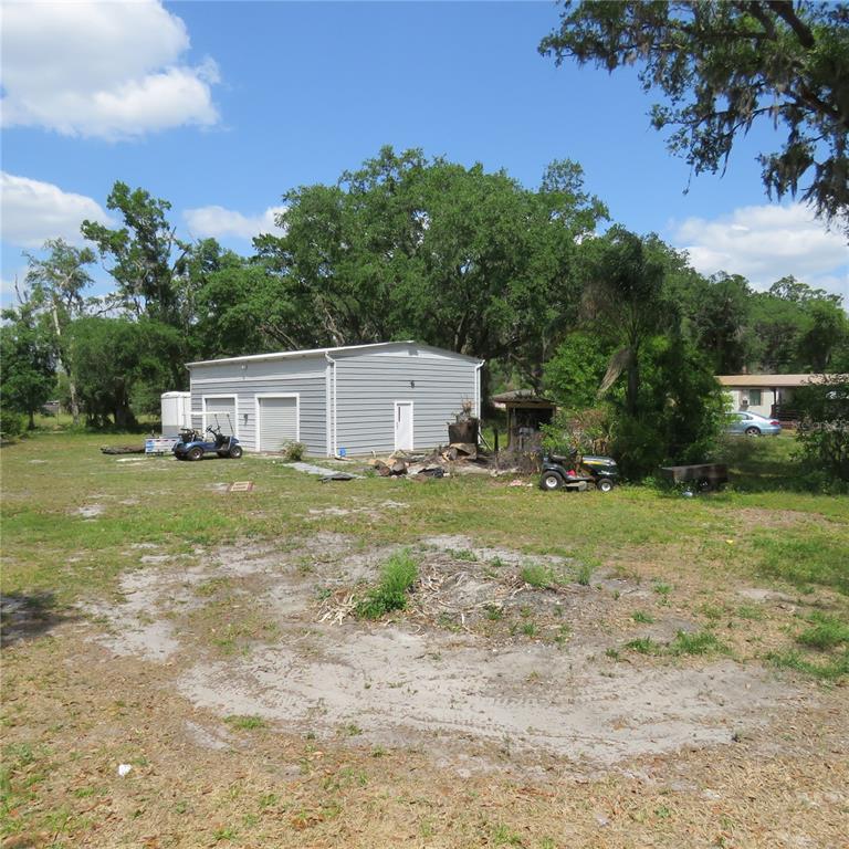 8505 Franklin Road Plant City, FL 33565 - Photo 24 of 25 a white house with a big yard and large trees with wooden fence
