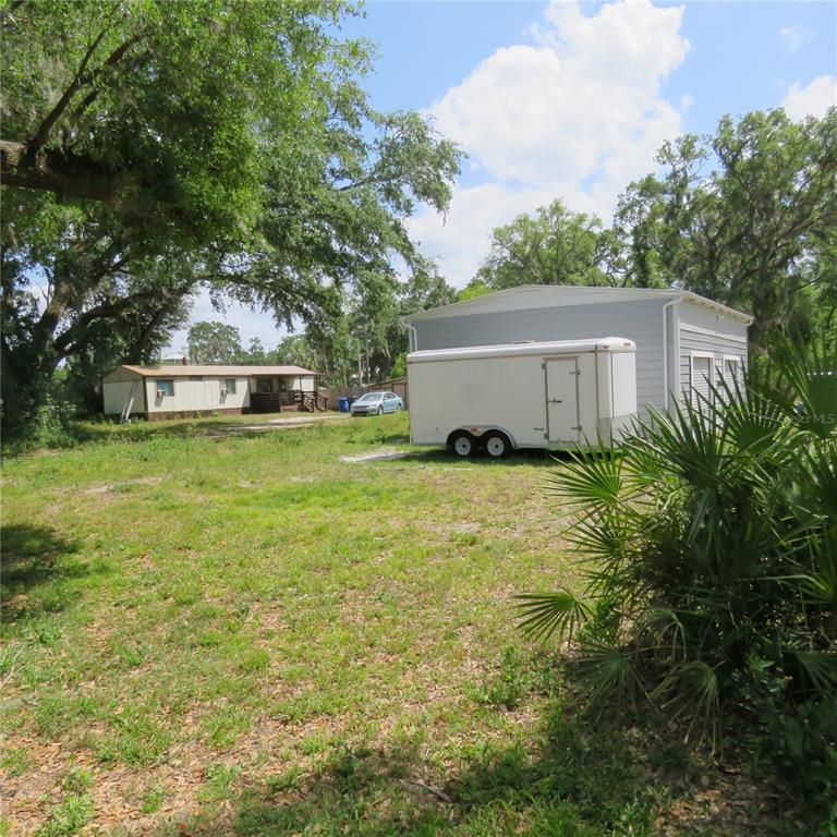 8505 Franklin Road Plant City, FL 33565 - Photo 9 of 25 a view of a house with a yard and a large tree