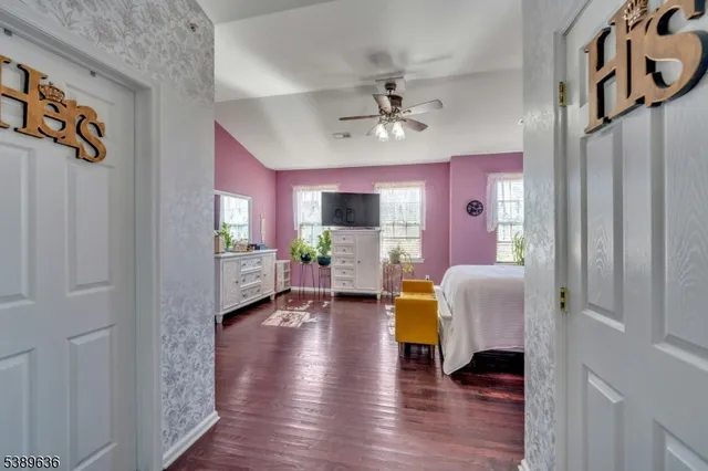 a view of living room with furniture and wooden floor