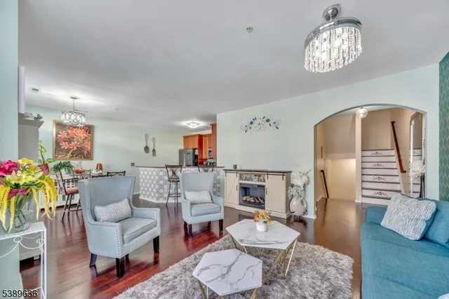 a living room with furniture and a chandelier