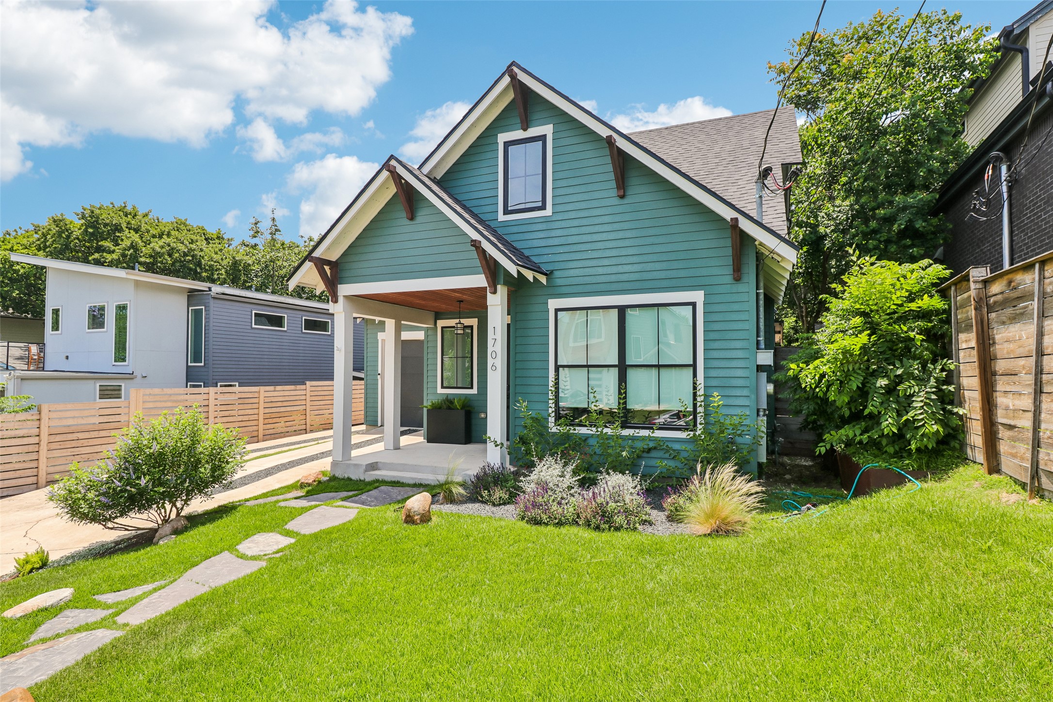 1706 Perez Street, Unit 1 Austin, TX 78721 - Photo 3 of 36 A charming teal facade with clean lines and a stone path beckons guests.