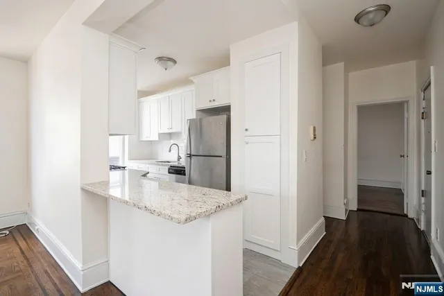 a kitchen with a refrigerator and a sink