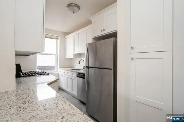 a kitchen with a refrigerator and a stove