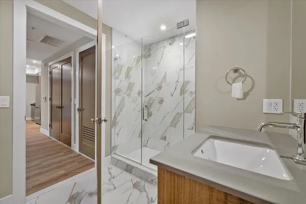 a bathroom with a sink a toilet and shower