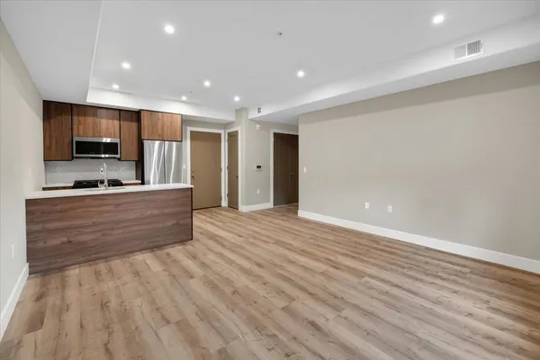 a view of kitchen with wooden floor and window