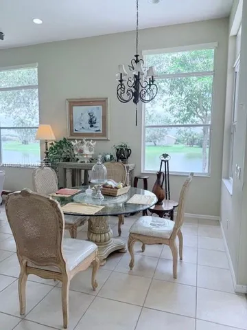 a view of a dining room with furniture wooden floor and chandelier