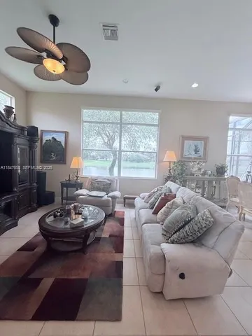 a living room with furniture and a large window