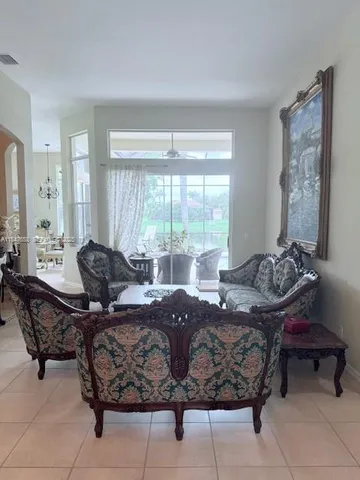 a living room with furniture and large windows