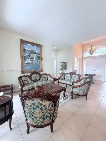 a living room with furniture a rug and a painting on the wall