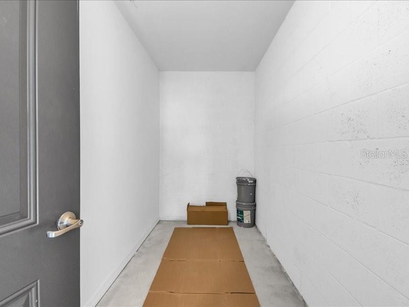 19116 Scallop Loop, Unit 303 Lakewood Ranch, FL 34211 - Photo 31 of 32 a view of a hallway with wooden floor and a bathroom