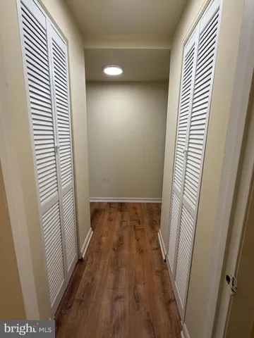 a view of a room with wooden floor