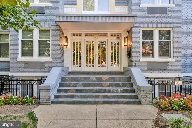 a front view of a house with potted plants