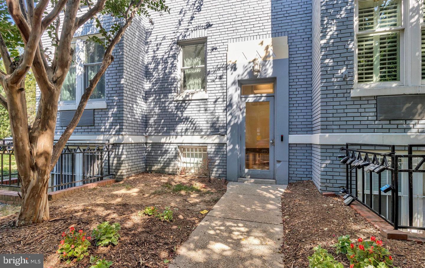 1901 16th Street Northwest, Unit 11 Washington, DC 20009 - Photo 3 of 13 a view of a house with brick wall and potted plants