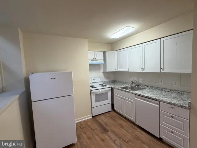a kitchen with a white cabinets and white appliances