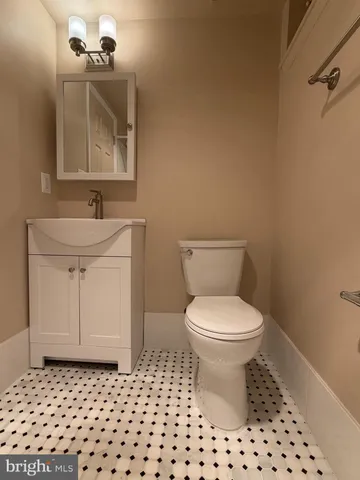 a bathroom with a toilet a sink and a mirror