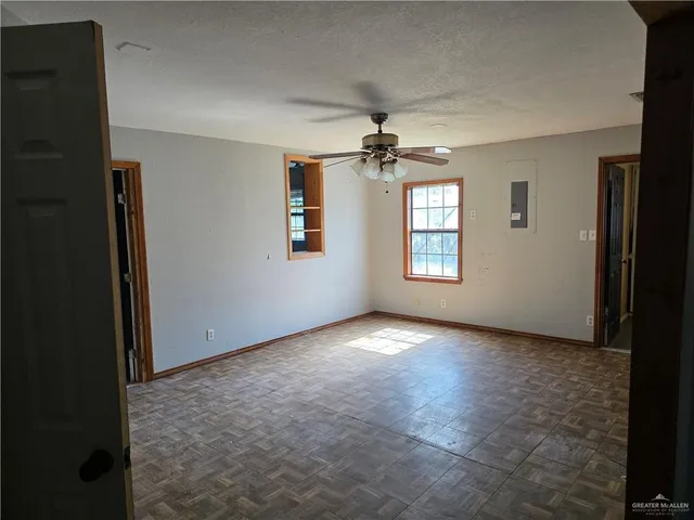 a view of a chandelier fan and windows