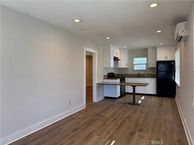 a kitchen with a refrigerator and a stove top oven