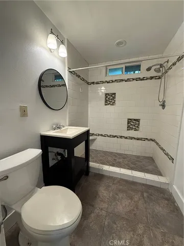 a bathroom with a sink a toilet a mirror and tub
