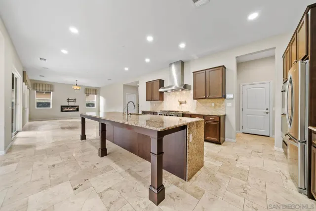 a kitchen with stainless steel appliances kitchen island granite countertop a sink and cabinets