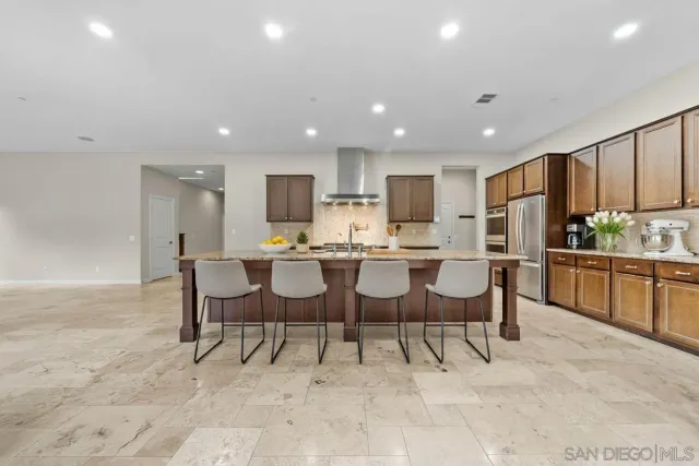 a large kitchen with a table and chairs