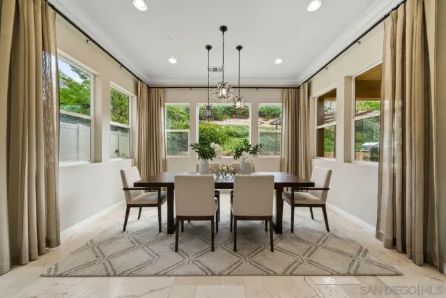 a view of a dining room with furniture large windows and wooden floor