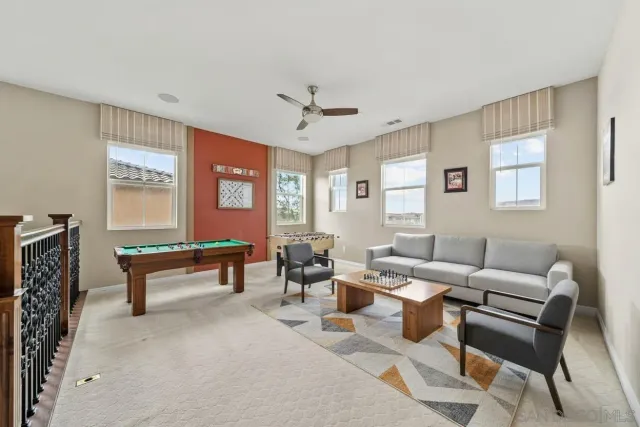 a living room with furniture a large window and a rug
